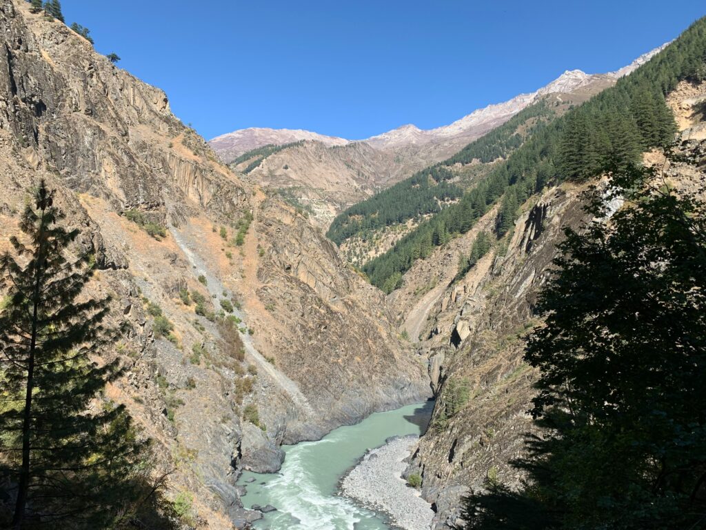 A beautiful view of Chenab River flowing between the mountais.