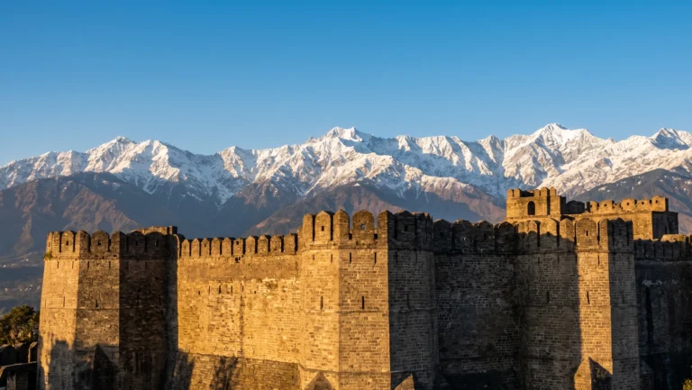 Kangra Fort battlements with Dhauladhar mountain range view Himachal Pradesh 2026.
