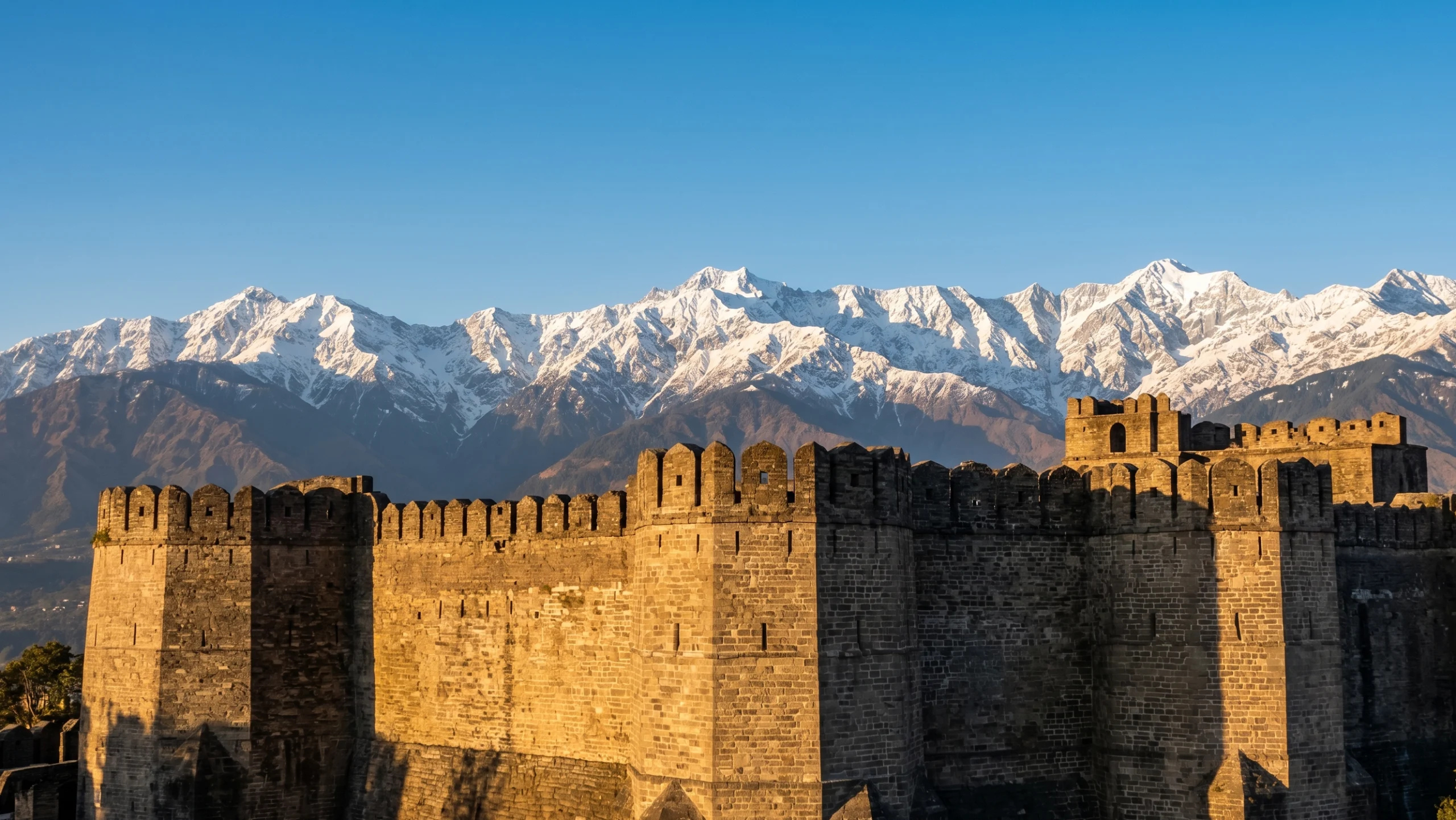 Kangra Fort battlements with Dhauladhar mountain range view Himachal Pradesh 2026.
